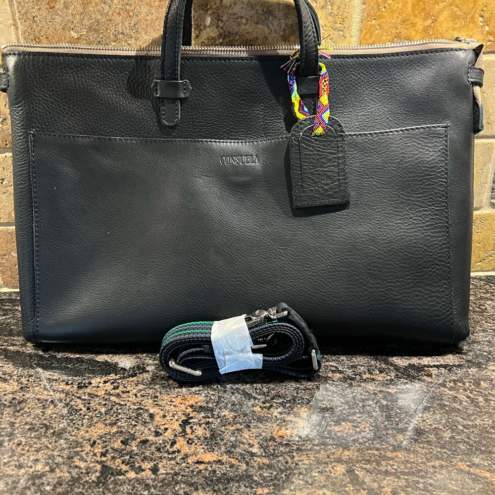 NWT Evie Crosstown amazing in black leather. NEVER USED.